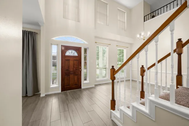 a view of entryway and hall with wooden floor
