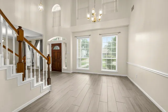 a view of a room with wooden floor and window