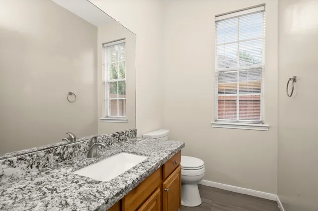 a view of an empty room with a fireplace and a window