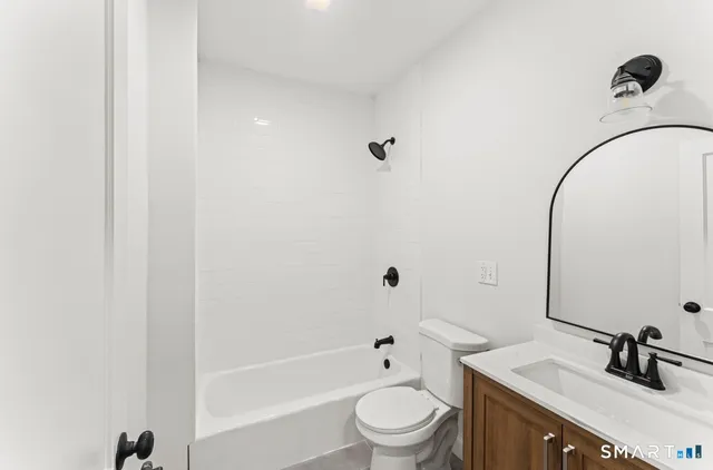 a bathroom with a sink a toilet and a tub