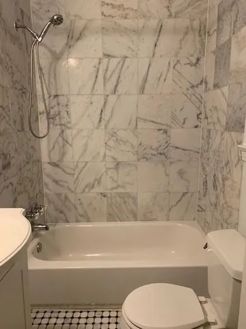a bathroom with a toilet and a bathtub