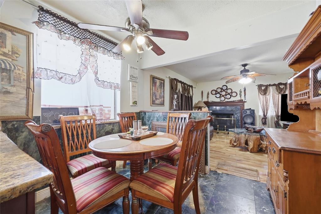 3027 Queens Gate Road Orlando, FL 32818 - Photo 15 of 34 a view of a dining room with furniture and a chandelier