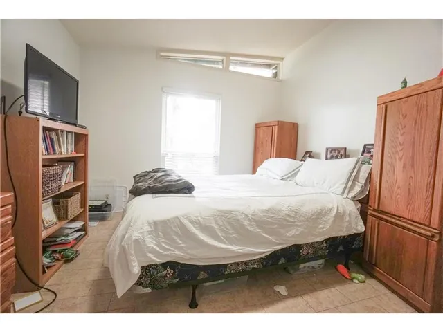 a bedroom with a bed and a television