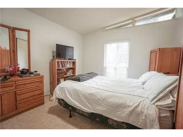a bedroom with a bed and a dresser
