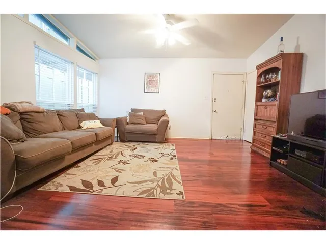 a living room with furniture window and wooden floor