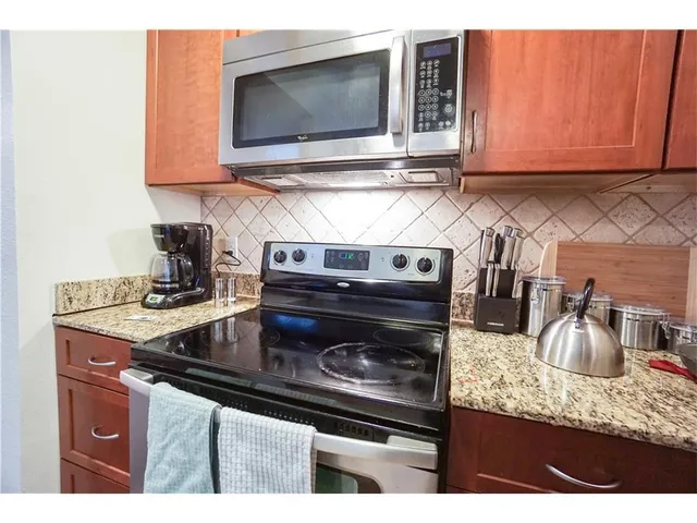 a kitchen with a stove microwave and sink
