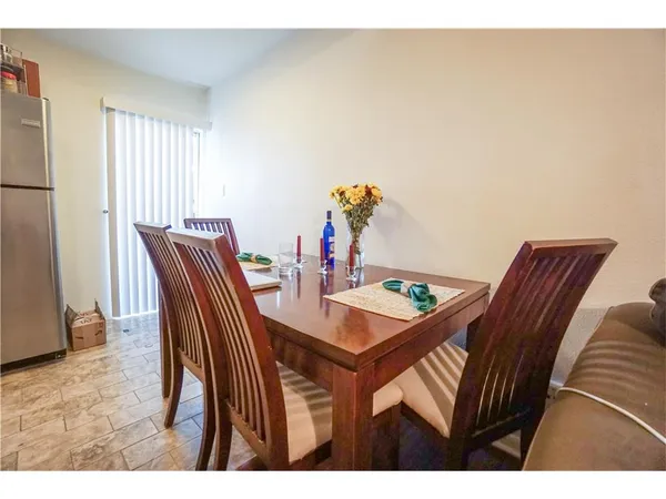 a view of a dining room with furniture and a window