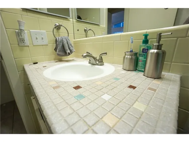 a bathroom with a sink and mirror