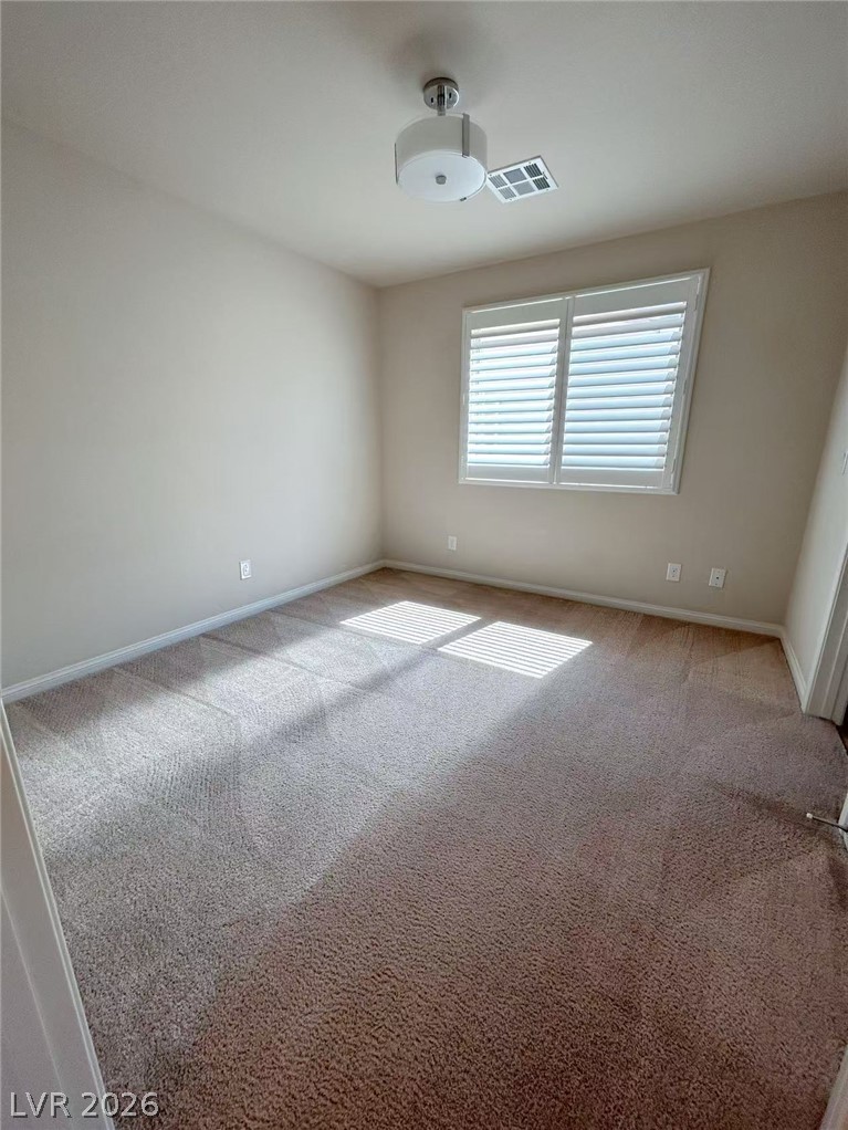 146 Tree Shot Court Las Vegas, NV 89113 - Photo 10 of 18 A well-lit bedroom features plush carpeting and window shutters.