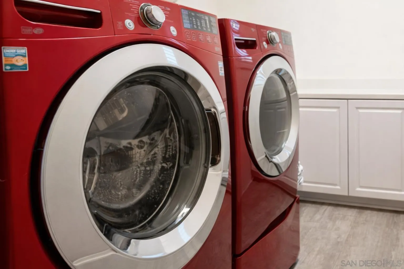 1132 Cherry Tree Lane Vista, CA 92084 - Photo 9 of 26 Laundry boasts full capacity wash & dryer, folding counter, hanging space plus additional storage cabinets!