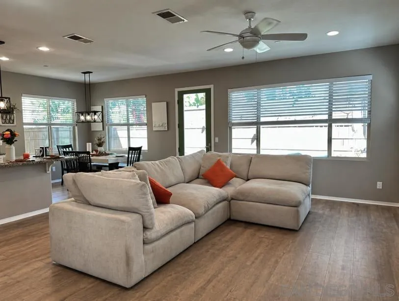 1132 Cherry Tree Lane Vista, CA 92084 - Photo 26 of 26 Living room is open floor plan wit tons of natural light, views to backyard, visibility into the kitchen and has a cracking fireplace