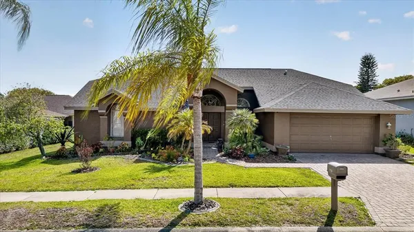 a front view of house with a garden