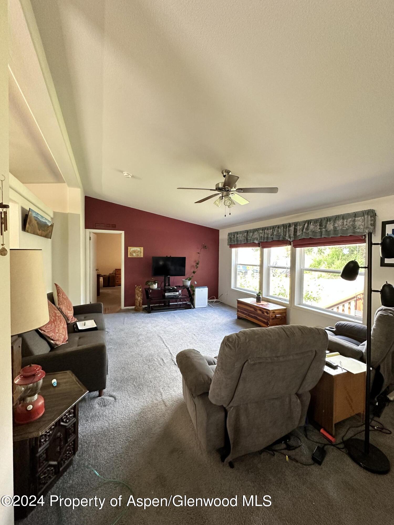 220 Clark Drive El Jebel, CO 81621 - Photo 2 of 12 a living room with furniture fireplace and a large window