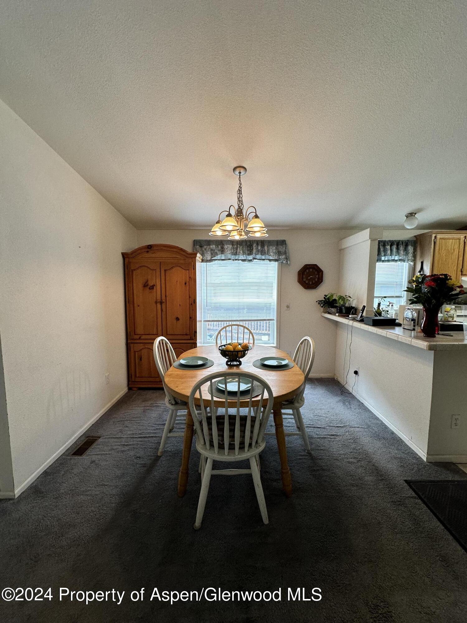 220 Clark Drive El Jebel, CO 81621 - Photo 3 of 12 a dining room with a table and chairs