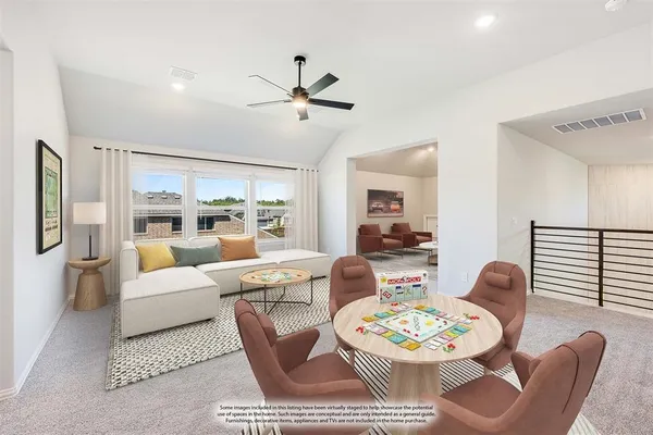 a view of a livingroom with a ceiling fan and window