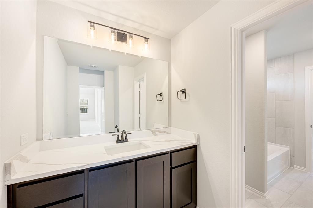 1025 Raptor Road Alvarado, TX 76009 - Photo 35 of 40 a bathroom with a sink double vanity and a mirror