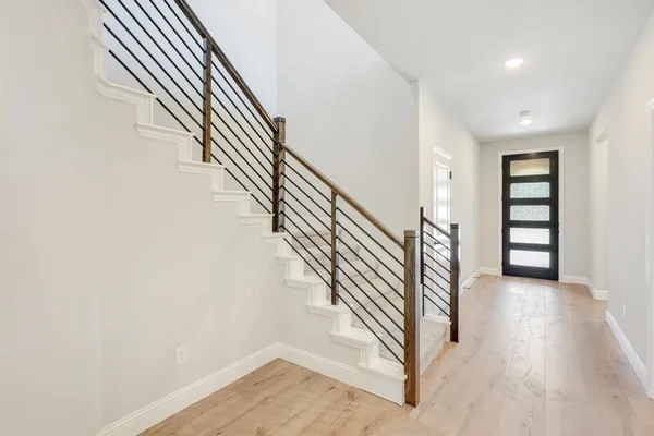 a view of empty room with wooden floor and fireplace