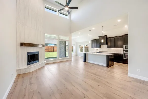 a kitchen with kitchen island granite countertop stainless steel appliances and wooden cabinets