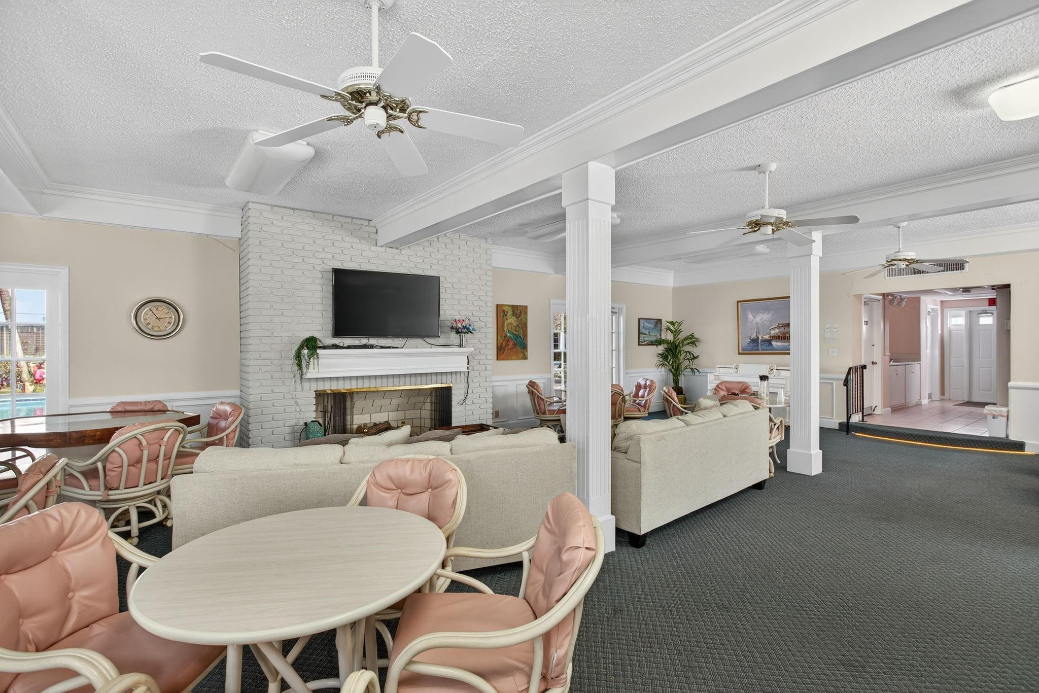 418 South Cypress Road, Unit 110 Pompano Beach, FL 33060 - Photo 22 of 28 a living room with furniture a fireplace and a flat screen tv