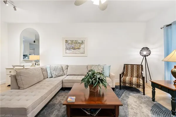 a living room with furniture a rug and a chandelier