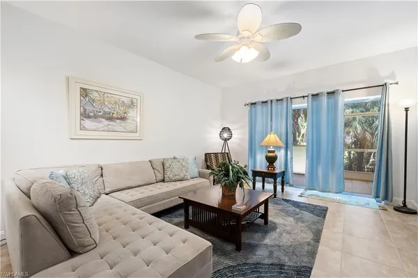 a living room with furniture a rug and a window