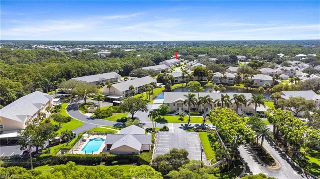 an aerial view of a house with a yard and swimming pool