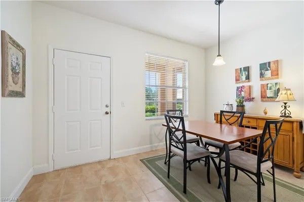 a view of a dining room with furniture and window