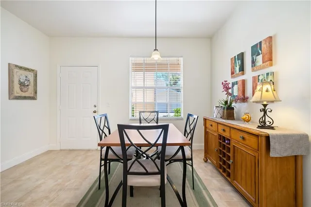 a dining room with furniture and window