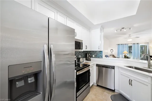 a kitchen with a sink and stainless steel appliances