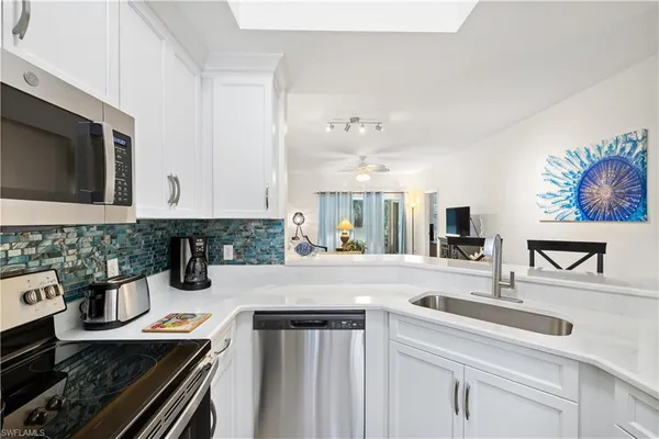 a kitchen with sink and cabinets