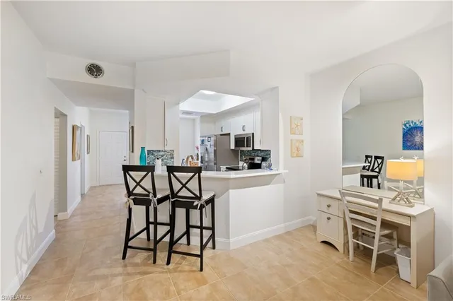 a living room with furniture and view of kitchen