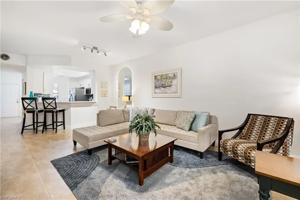 a living room with furniture and a potted plant