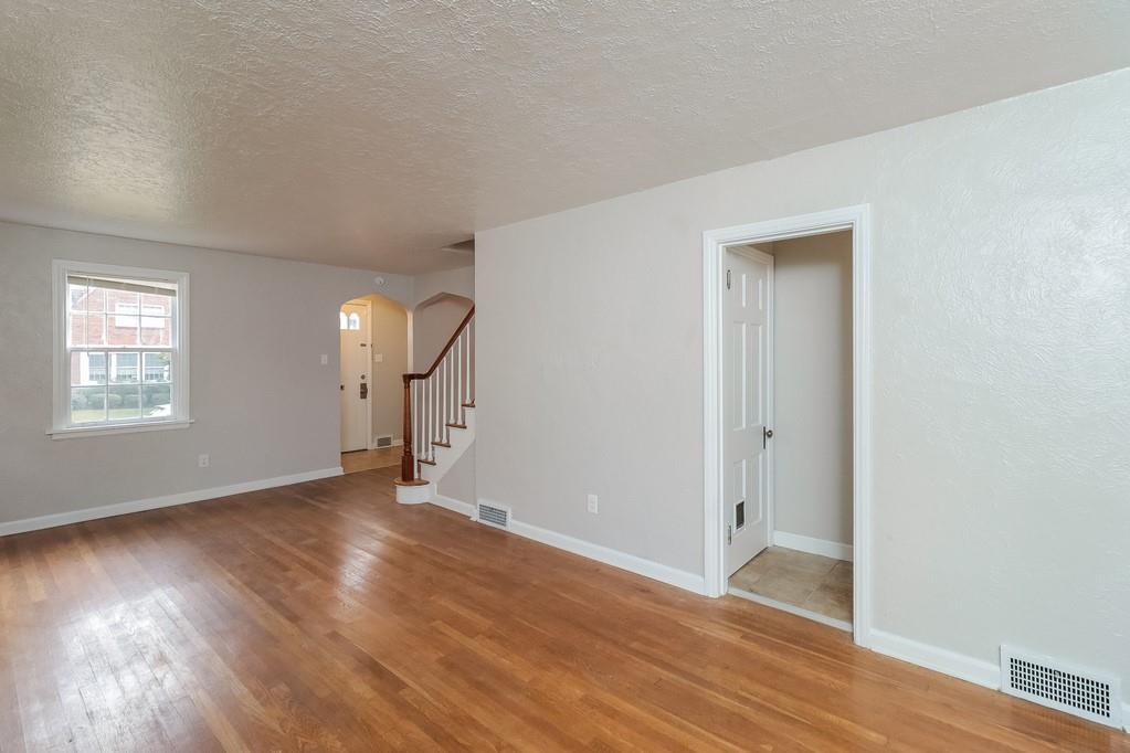 18 Alice Street Pittsburgh, PA 30342 - Photo 5 of 11 an empty room with wooden floor and windows
