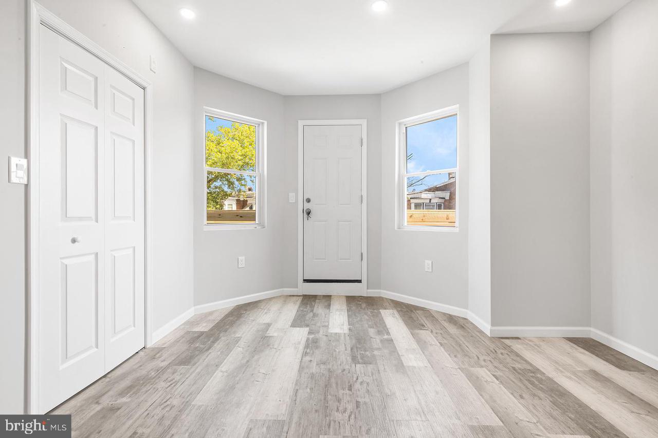 5706 Chestnut Street, Unit 2 Philadelphia, PA 19139 - Photo 2 of 8 wooden floor in an empty room with a window