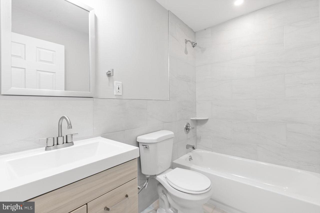 5706 Chestnut Street, Unit 2 Philadelphia, PA 19139 - Photo 6 of 8 a bathroom with a sink a toilet and a bathtub