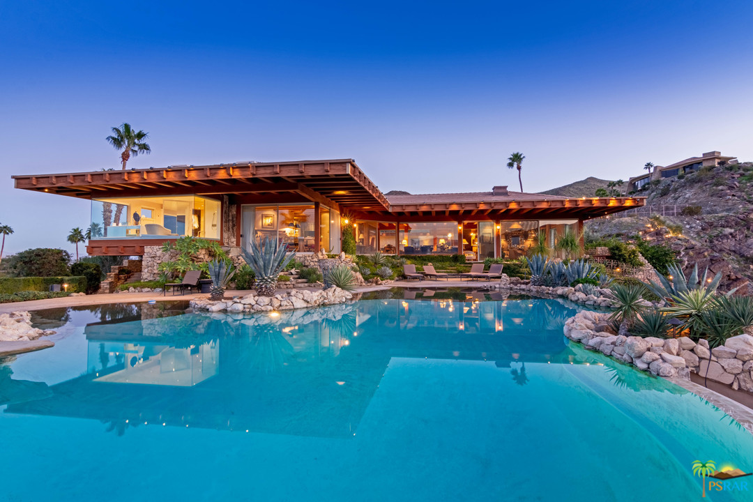 a view of a house with swimming pool yard and outdoor seating