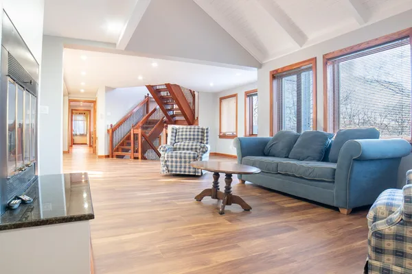 a living room with furniture and a wooden floor
