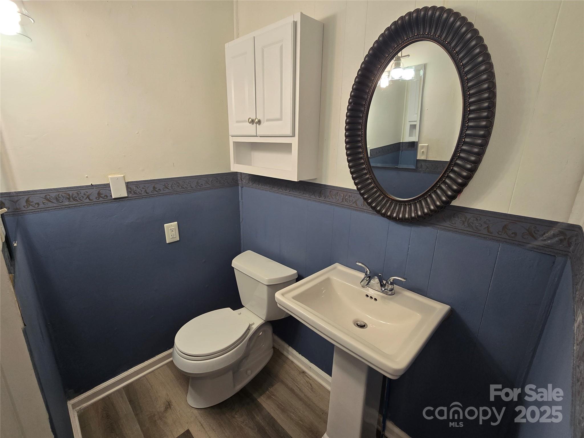 1900 Double Oaks Road Charlotte, NC 28206 - Photo 11 of 22 a bathroom with a toilet a sink and a mirror
