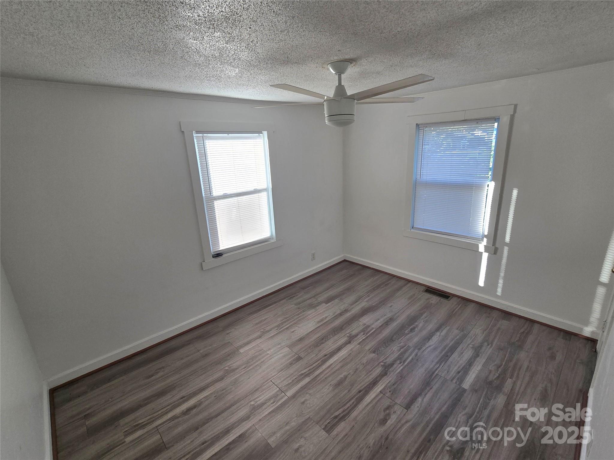 1900 Double Oaks Road Charlotte, NC 28206 - Photo 13 of 22 an empty room with wooden floor closet and windows
