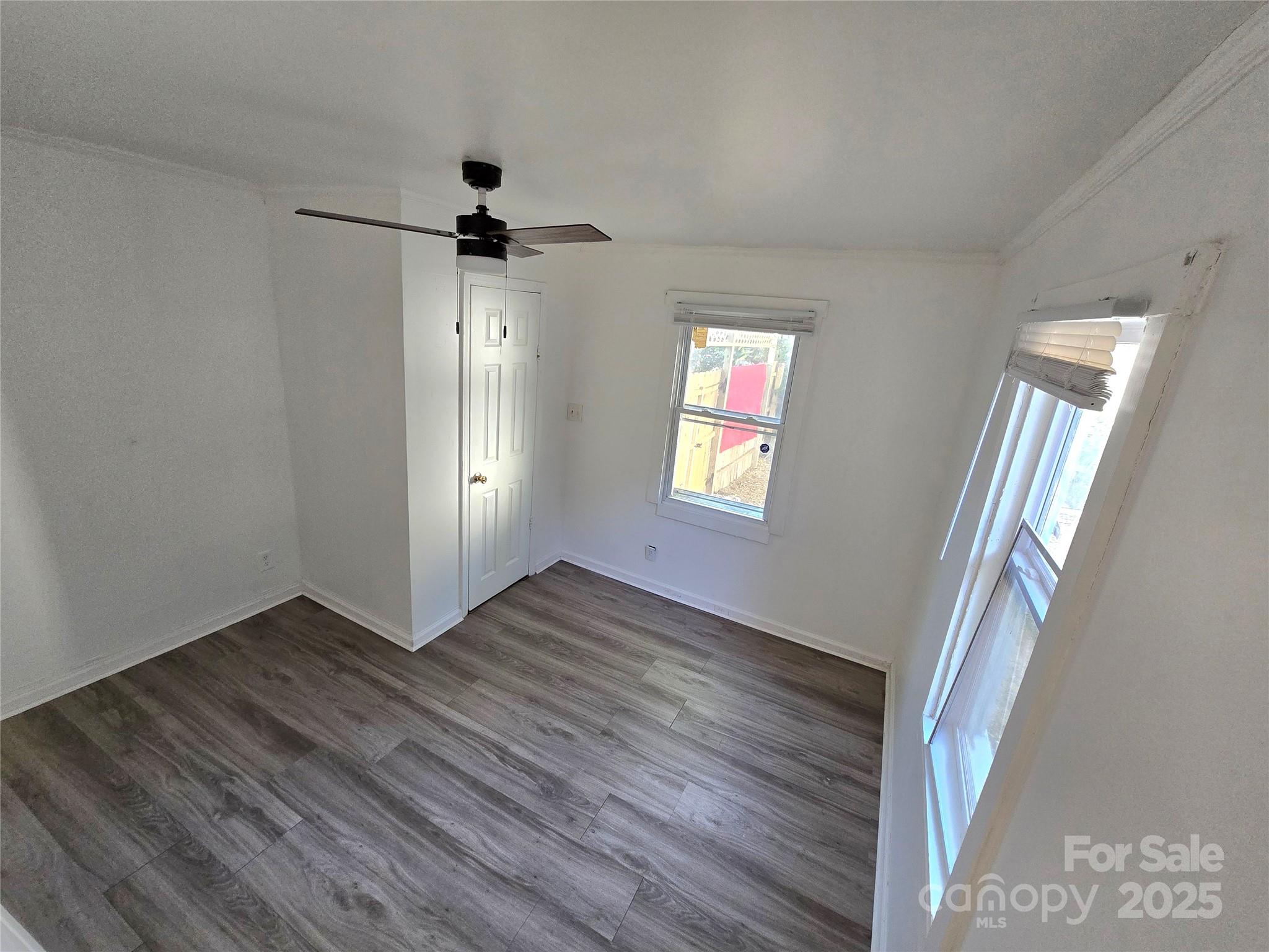 1900 Double Oaks Road Charlotte, NC 28206 - Photo 14 of 22 wooden floor in an empty room with a window