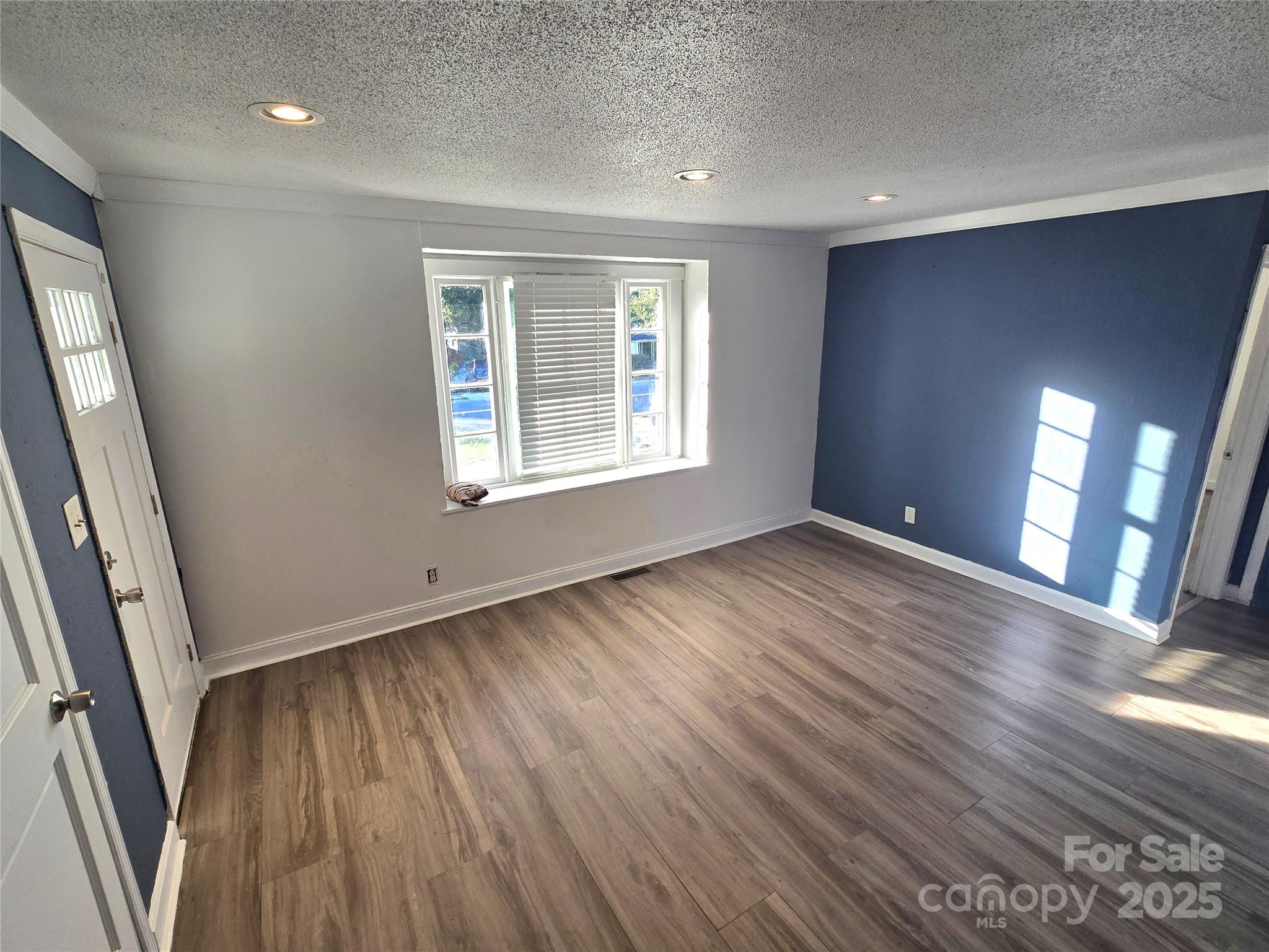 1900 Double Oaks Road Charlotte, NC 28206 - Photo 4 of 22 an empty room with wooden floor and windows