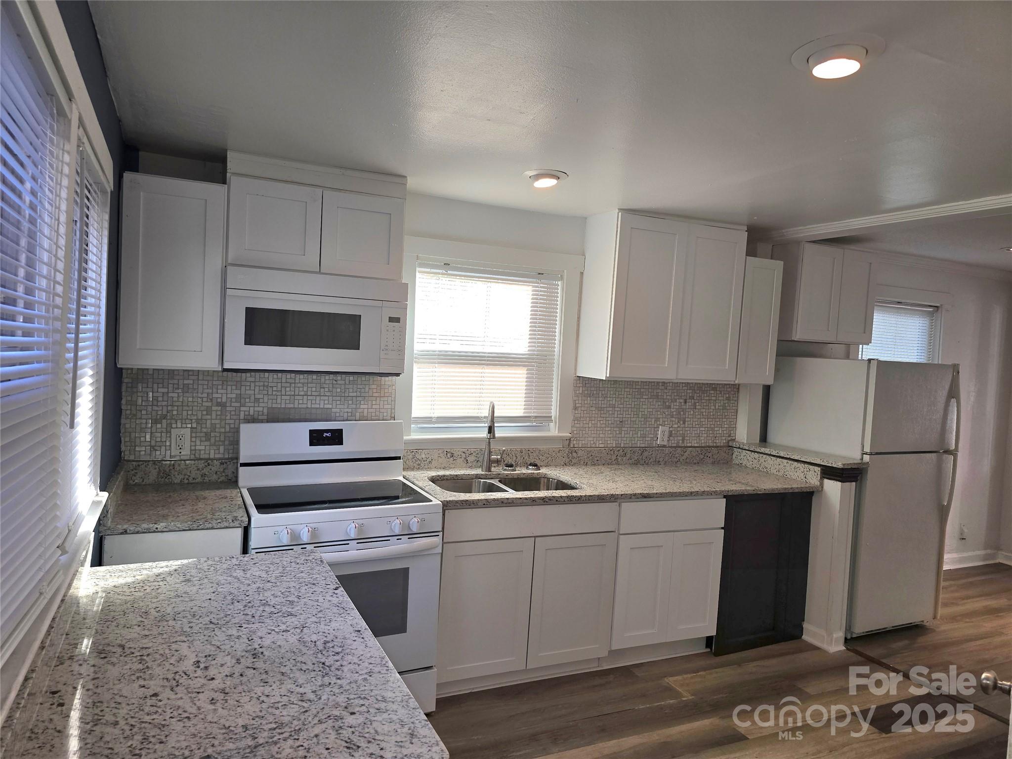 1900 Double Oaks Road Charlotte, NC 28206 - Photo 7 of 22 a kitchen with a sink stove and microwave