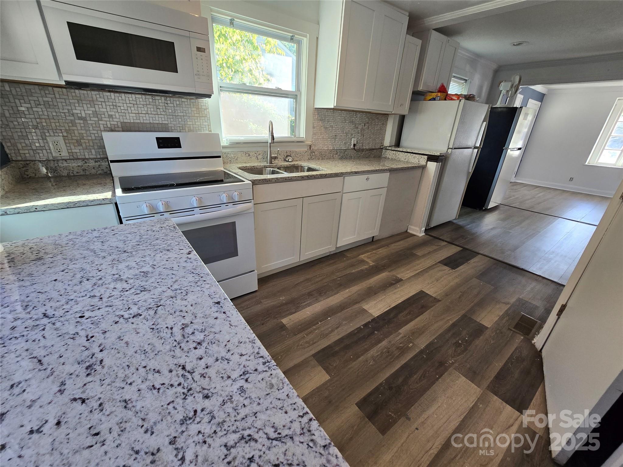 1900 Double Oaks Road Charlotte, NC 28206 - Photo 8 of 22 a kitchen with a stove a sink and a microwave