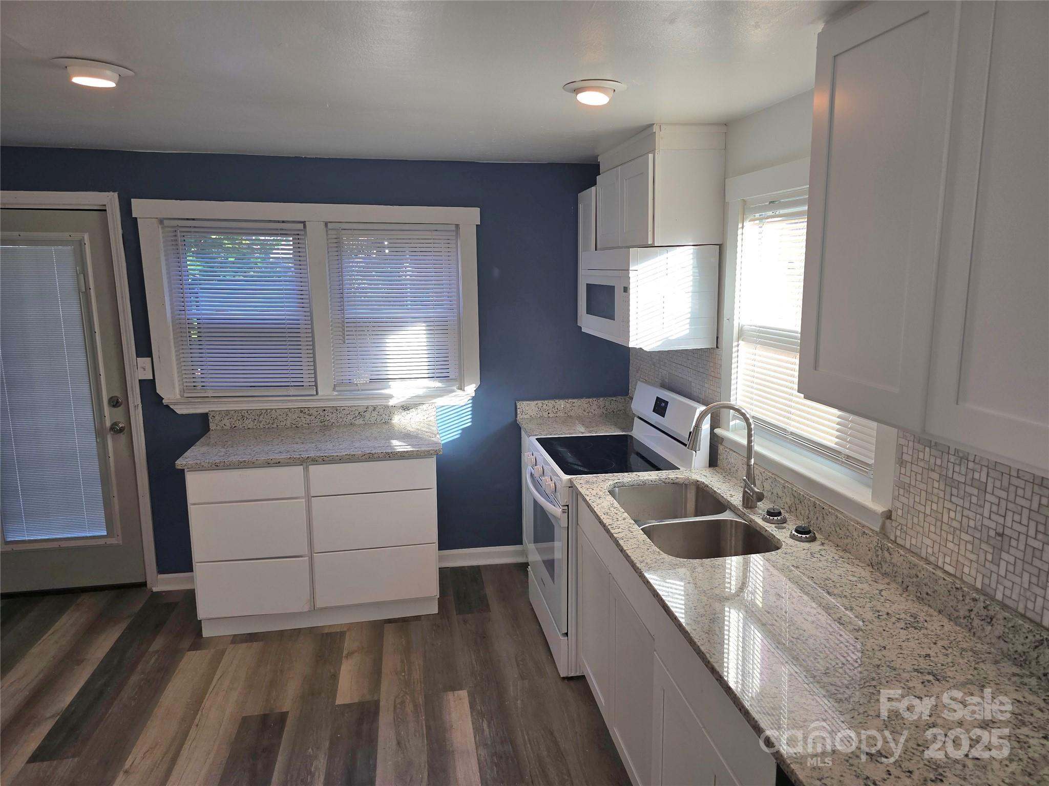 1900 Double Oaks Road Charlotte, NC 28206 - Photo 10 of 22 a kitchen with sink cabinets and stove