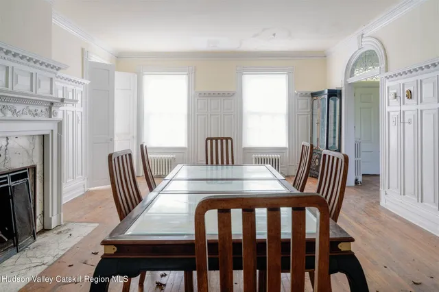a view of a hallway with wooden floor and stairs