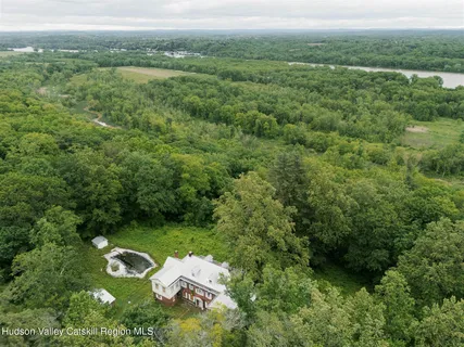 an aerial view of a house with a yard