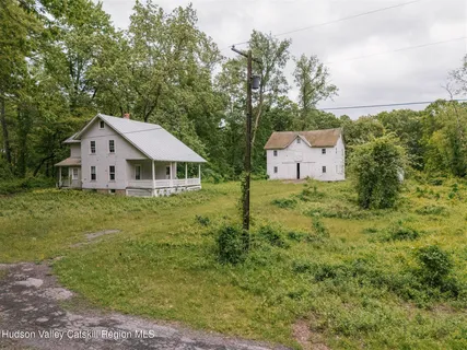 a view of a house with a yard and deck