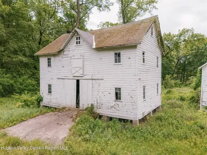 a aerial view of a house with a yard and green space