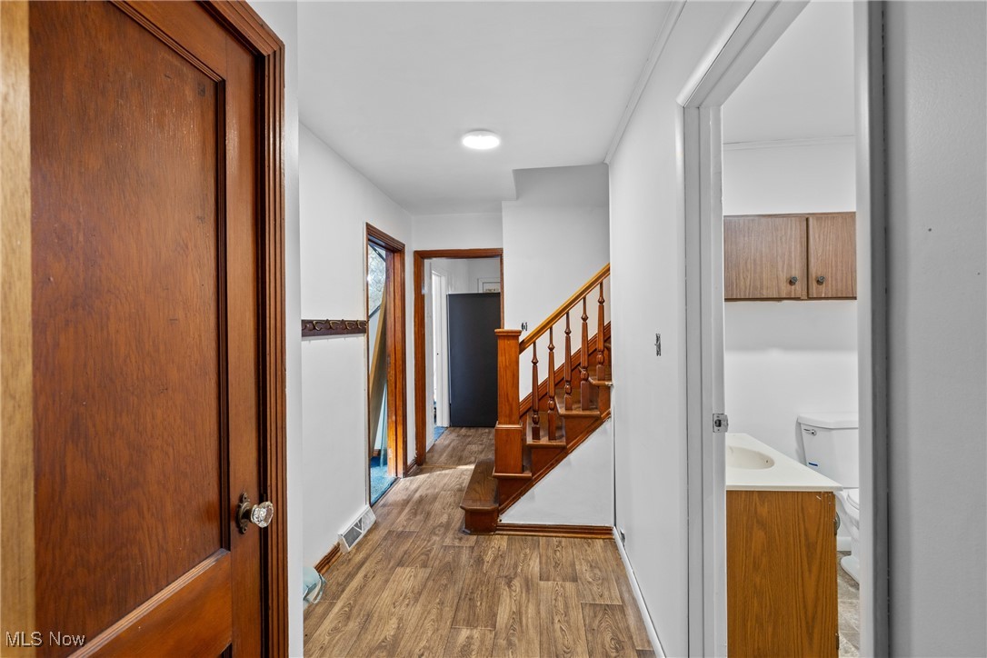 102 Potrock Road Wellsburg, WV 26070 - Photo 12 of 42 Corridor featuring light wood-style floors and stairway