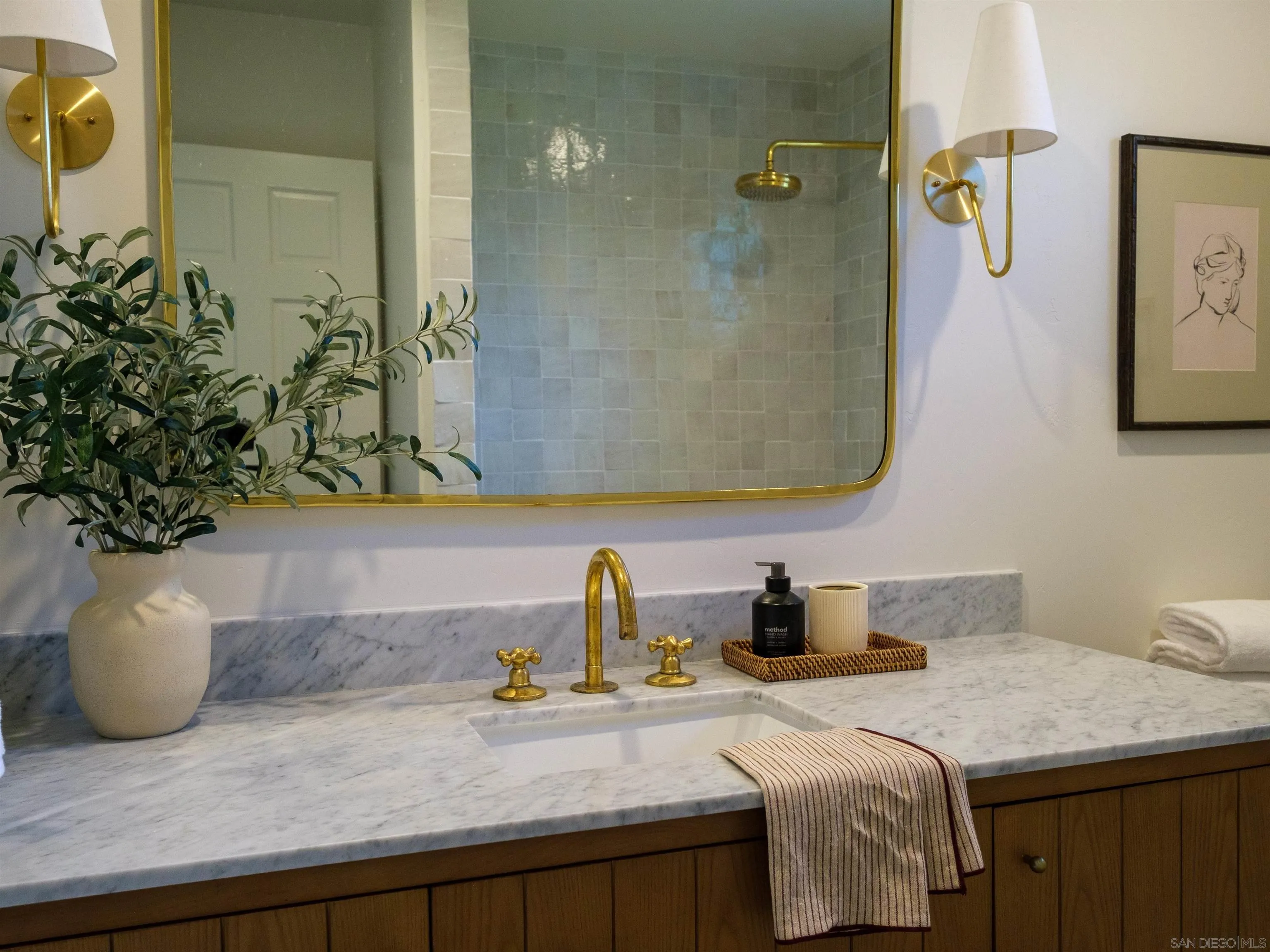 1915 Montgomery Avenue Cardiff-by-the-Sea, CA 92007 - Photo 14 of 32 a bathroom with a granite countertop sink a mirror and shower